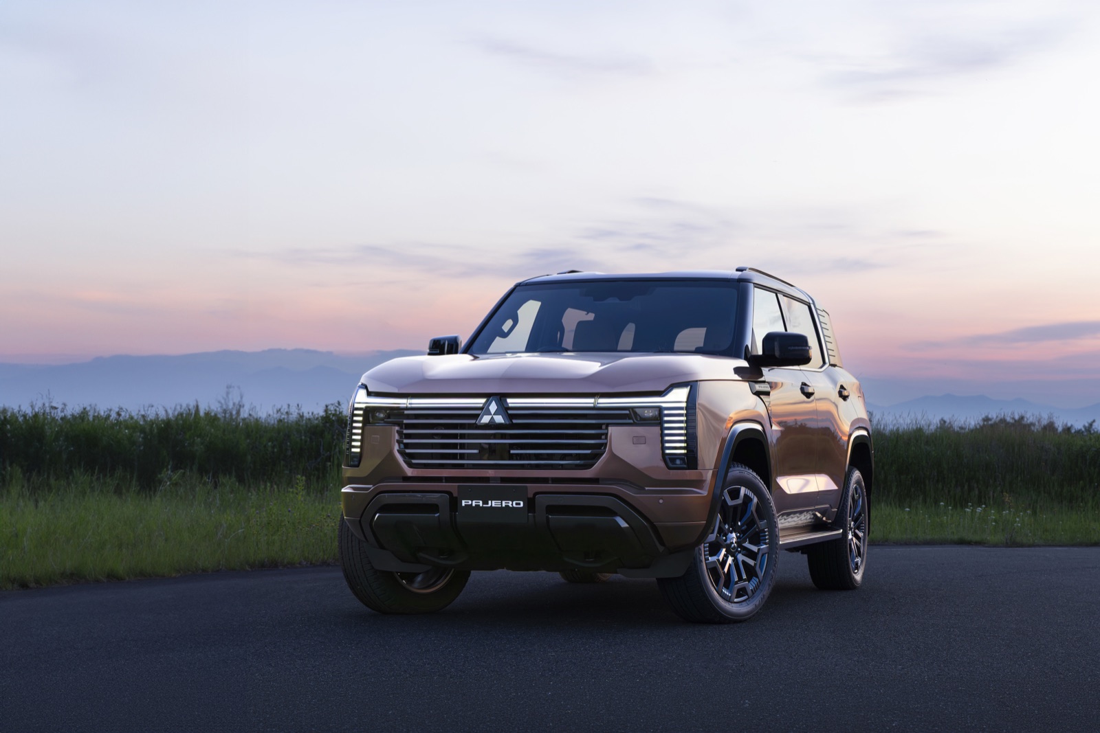 The all-new Mitsubishi Pajero in bronze photographed at dusk, the full-size seven-seat SUV that returns to Middle East markets from fiscal 2027.